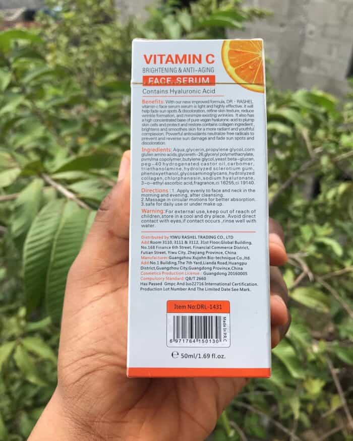 Person holding Back side of Dr Rashel Vitamin C Face Serum box with detailed product benefits, ingredients, directions, and manufacturer information