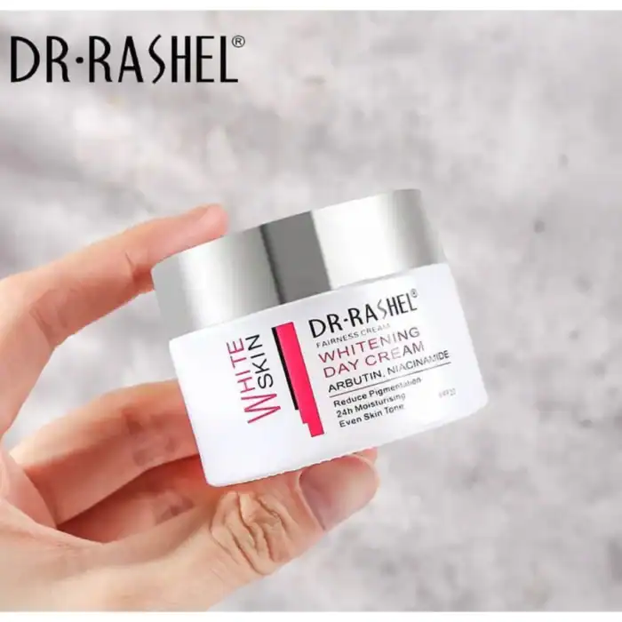 Hand holding Dr Rashel Whitening Day Cream jar with Arbutin and Niacinamide formula