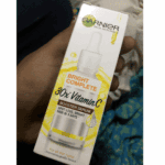 Garnier Bright Complete 30x Vitamin C Booster Serum front box view held in hand, 30ml