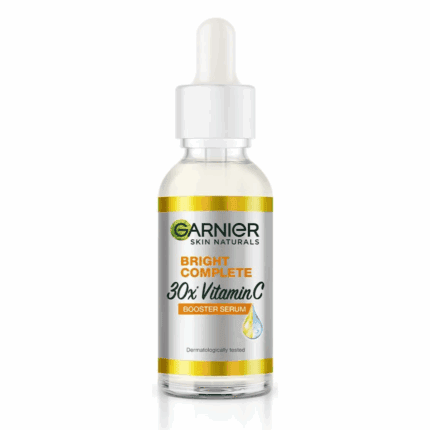 Garnier Skin Naturals Bright Complete 30x Vitamin C Booster Serum in a 30ml transparent glass bottle with a white dropper cap.