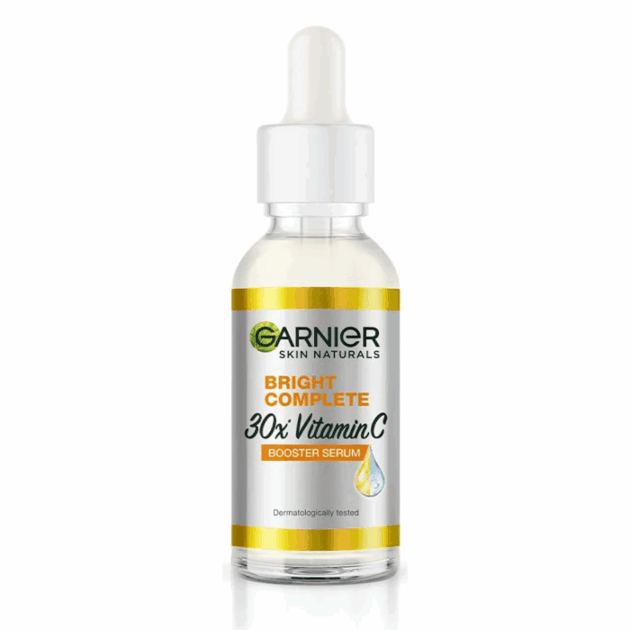 Garnier Skin Naturals Bright Complete 30x Vitamin C Booster Serum in a 30ml transparent glass bottle with a white dropper cap.