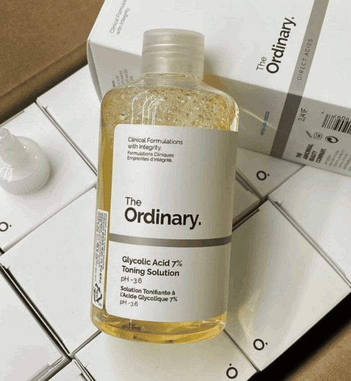 Close-up of The Ordinary Glycolic Acid 7% Toning Solution bottle placed on top of stacked product boxes