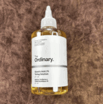 The Ordinary Glycolic Acid 7% Toning Solution bottle on a brown textured surface