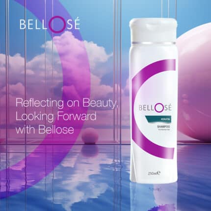 Bellosé Keratin Shampoo 250ml white bottle with purple design, placed in a reflective setting with sky and cloud background and brand slogan