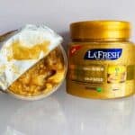 La Fresh Gold Scrub jar 500ml with gold cap, shown alongside an opened jar revealing gold-colored scrub inside