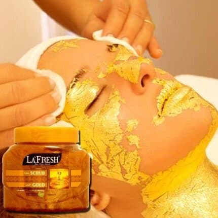 Facial treatment with gold mask applied to a woman's face, using La Fresh Gold Scrub jar 500ml