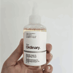 Hand holding The Ordinary Glycolic Acid 7% Exfoliating Toner 100ml with clear label