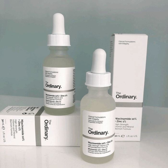 Two bottles of The Ordinary Niacinamide 10% + Zinc 1% serum placed with white product boxes, minimalistic packaging design, high-strength blemish and oil-control serum for clearer skin.