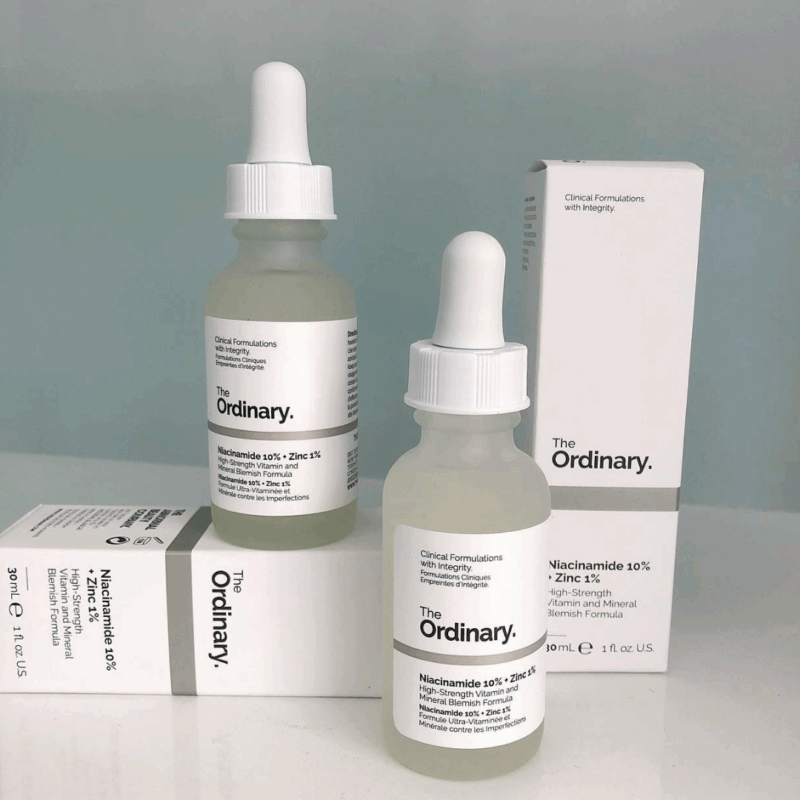 Two bottles of The Ordinary Niacinamide 10% + Zinc 1% serum placed with white product boxes, minimalistic packaging design, high-strength blemish and oil-control serum for clearer skin.