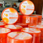 Stacked jars of Dr Rashel Vitamin C Soothing Gel 99% in orange packaging, brightening and anti-aging gel with Vitamin C, displayed in bulk.