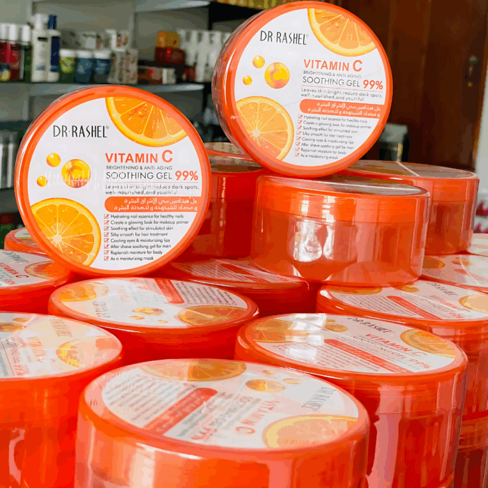 Stacked jars of Dr Rashel Vitamin C Soothing Gel 99% in orange packaging, brightening and anti-aging gel with Vitamin C, displayed in bulk.