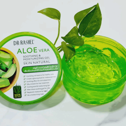 Open jar of Dr Rashel Aloe Vera Soothing & Moisturizing Gel showing clear gel texture, placed beside its green lid featuring aloe leaf graphics, with fresh green leaves for a natural skincare look on a white background.