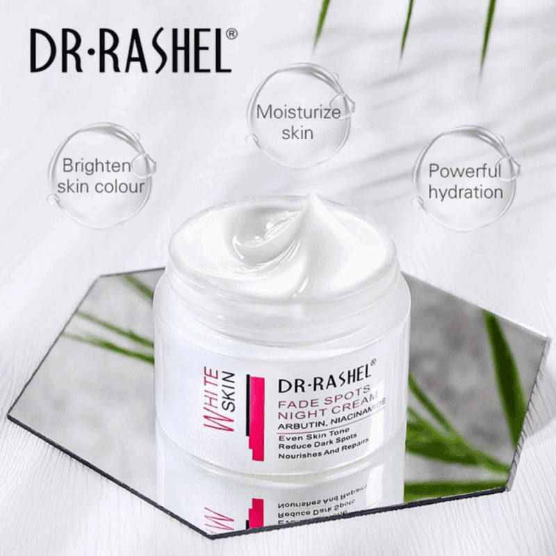 Open jar of Dr Rashel White Skin Fade Spots Night Cream with creamy white texture, placed on a reflective mirror surface. Text highlights benefits: brighten skin tone, moisturize skin, and provide powerful hydration.