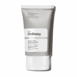 The Ordinary Azelaic Acid Suspension 10% in a sleek grey squeeze tube with white label, photographed against a plain white background. A multifunctional brightening cream for uneven tone and dull skin.