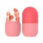 Pink capsule-shaped ice roller mold with grapefruit slices inside.