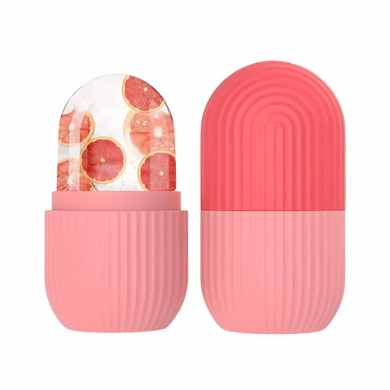 Pink capsule-shaped ice roller mold with grapefruit slices inside.