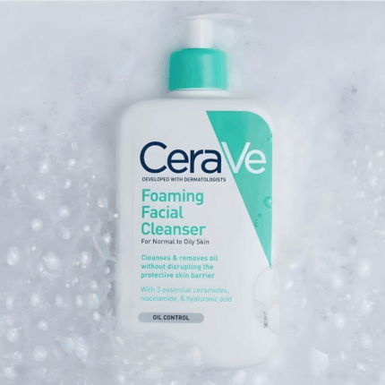 CeraVe Foaming Facial Cleanser bottle on a bed of foamy bubbles.