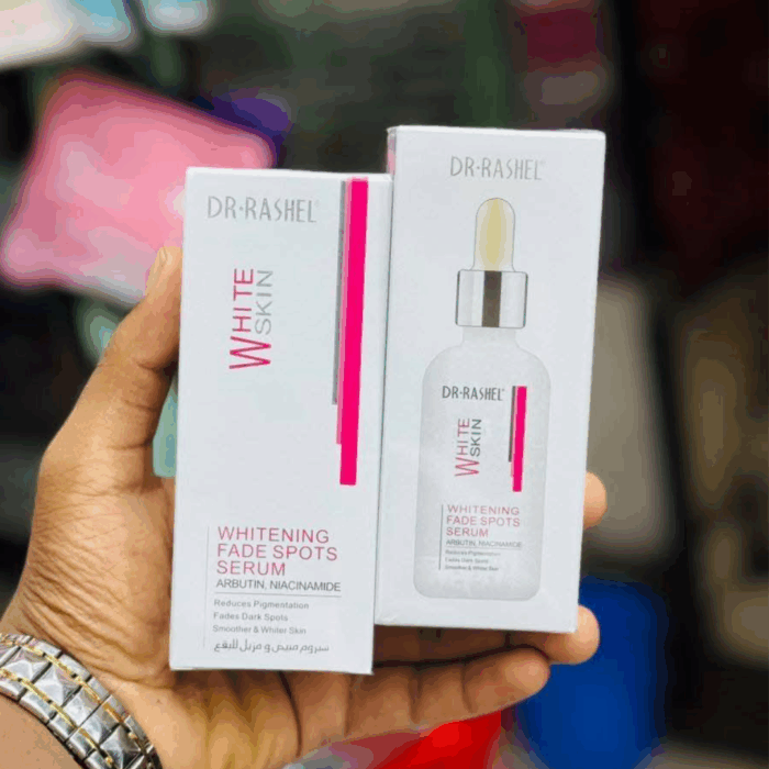 Hand holding Dr Rashel Whitening Fade Spots Serum box with bottle inside