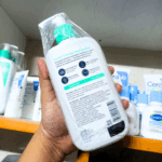Back view of CeraVe Foaming Facial Cleanser bottle showing ingredients and product details.