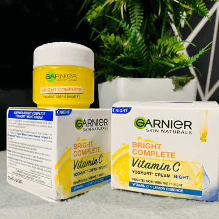 Garnier Bright Complete Vitamin C Yoghurt Night Cream jar with packaging boxes, enriched with Vitamin C and lemon essence for brighter skin overnight.
