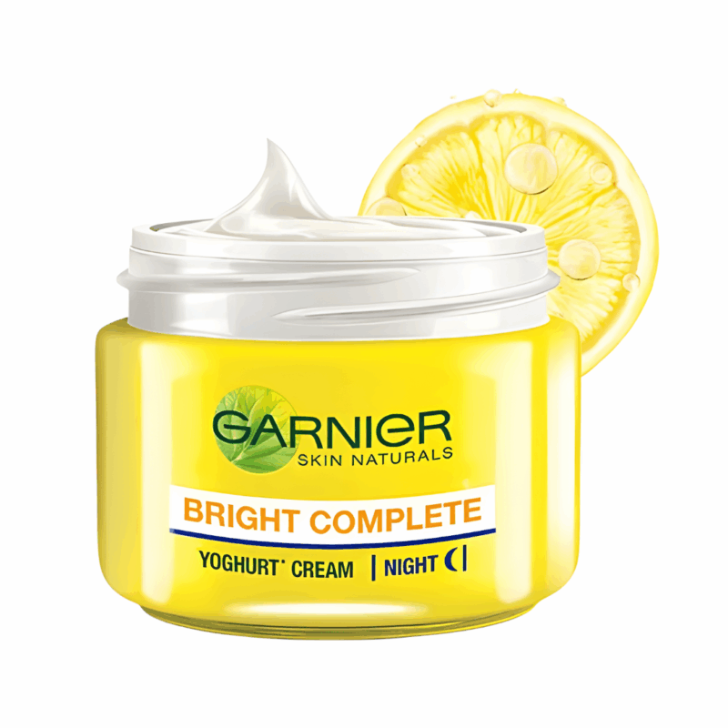 Garnier Bright Complete Vitamin C Yoghurt Night Cream in yellow jar with lemon slice background, nourishing night cream for bright and glowing skin.
