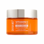A jar of Dr Rashel Vitamin C Brightening & Anti-Aging Day Cream featuring a silver lid and bright orange container, labeled with niacinamide and antioxidant benefits for even skin tone.