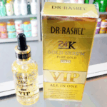 Dr Rashel 24K Gold Serum bottle with gold flakes placed beside the shiny gold VIP box labeled “Pure Gold 99.9%” and “All In One.”