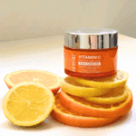 A jar of Dr Rashel Vitamin C Brightening & Anti-Aging Day Cream placed on fresh orange and lemon slices, symbolizing vitamin-rich skincare for bright and even-toned skin.