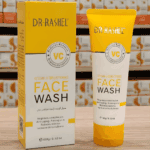 Dr Rashel Vitamin C Brightening Face Wash tube and packaging box displayed on a wooden surface, formulated to brighten complexion and reduce redness.