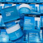 Multiple Neutrogena Hydro Boost Water Gel jars and boxes arranged together, featuring the blue and white packaging design. The image highlights the product’s key benefits — Hyaluronic Acid and 72-hour hydration for normal to combination skin.