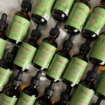 Multiple Mielle Rosemary Mint scalp and hair strengthening oil bottles arranged in bulk flat lay view.