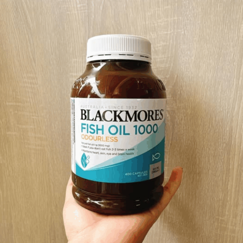 Hand holding Blackmores Fish Oil 1000 odourless omega-3 supplement bottleHand holding Blackmores Fish Oil 1000 odourless omega-3 supplement bottle