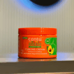 Cantu Avocado Hydrating Curling Cream jar displayed on shelf front label view