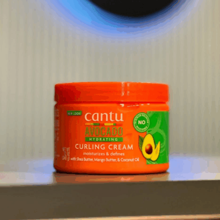 Cantu Avocado Hydrating Curling Cream jar displayed on shelf front label view