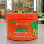 Close up of Cantu Avocado Hydrating Curling Cream showing moisturizing and defining formula