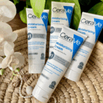 Multiple CeraVe Moisturizing Cream tubes arranged on woven mat with natural decor highlighting rich texture formula