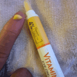 Garnier Vitamin C eye cream texture shown on fingertip from applicator tip