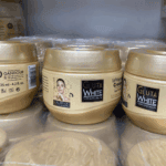 Multiple Gluta White glutathione collagen whitening cream jars arranged in storage showing bulk product stock