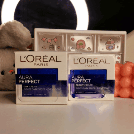 L’Oréal Paris Aura Perfect day cream and night cream boxes displayed together on vanity table