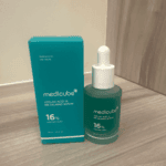Medicube Azelaic Acid 16 BB Calming Serum bottle placed beside box on flat surface