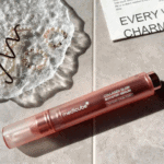 Medicube Collagen Glow Booster Serum laid flat showcasing rose gold serum pen design