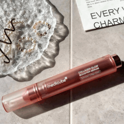 Medicube Collagen Glow Booster Serum laid flat showcasing rose gold serum pen design