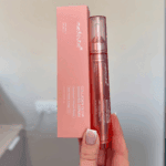 Medicube Collagen Glow Booster Serum held with original box packaging