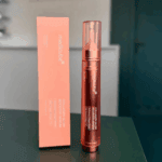 Medicube Collagen Glow Booster Serum standing next to packaging on tabletop