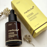 Medicube Glutathione Glow Serum bottle placed beside original yellow packaging box
