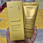 Medicube Kojic Acid Turmeric Night Wrapping Mask tube and box held in hand showing night care skincare packaging