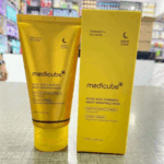 Front view of Medicube Kojic Acid Turmeric Night Wrapping Mask tube and box displayed on a counter