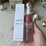 Medicube PDRN Pink Glutathione Serum Mist bottle and box packaging held in hand