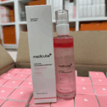 Medicube PDRN Pink Glutathione Serum Mist bottle and box displayed on stacked product boxes