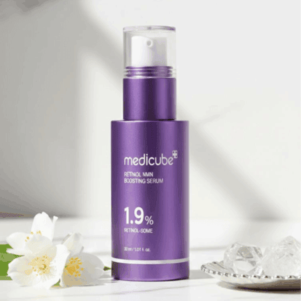 Medicube Retinol NMN Boosting Serum 1.9% displayed with flowers and decorative elements
